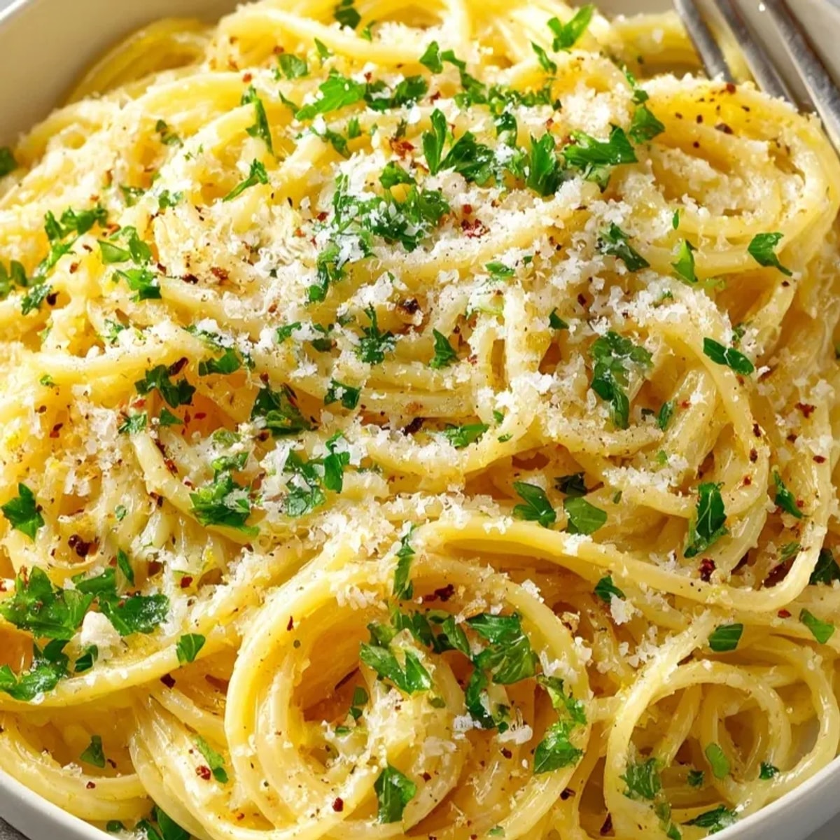 Close-up of creamy One-Pot Lemon Garlic Pasta, garnished with parsley and parmesan.