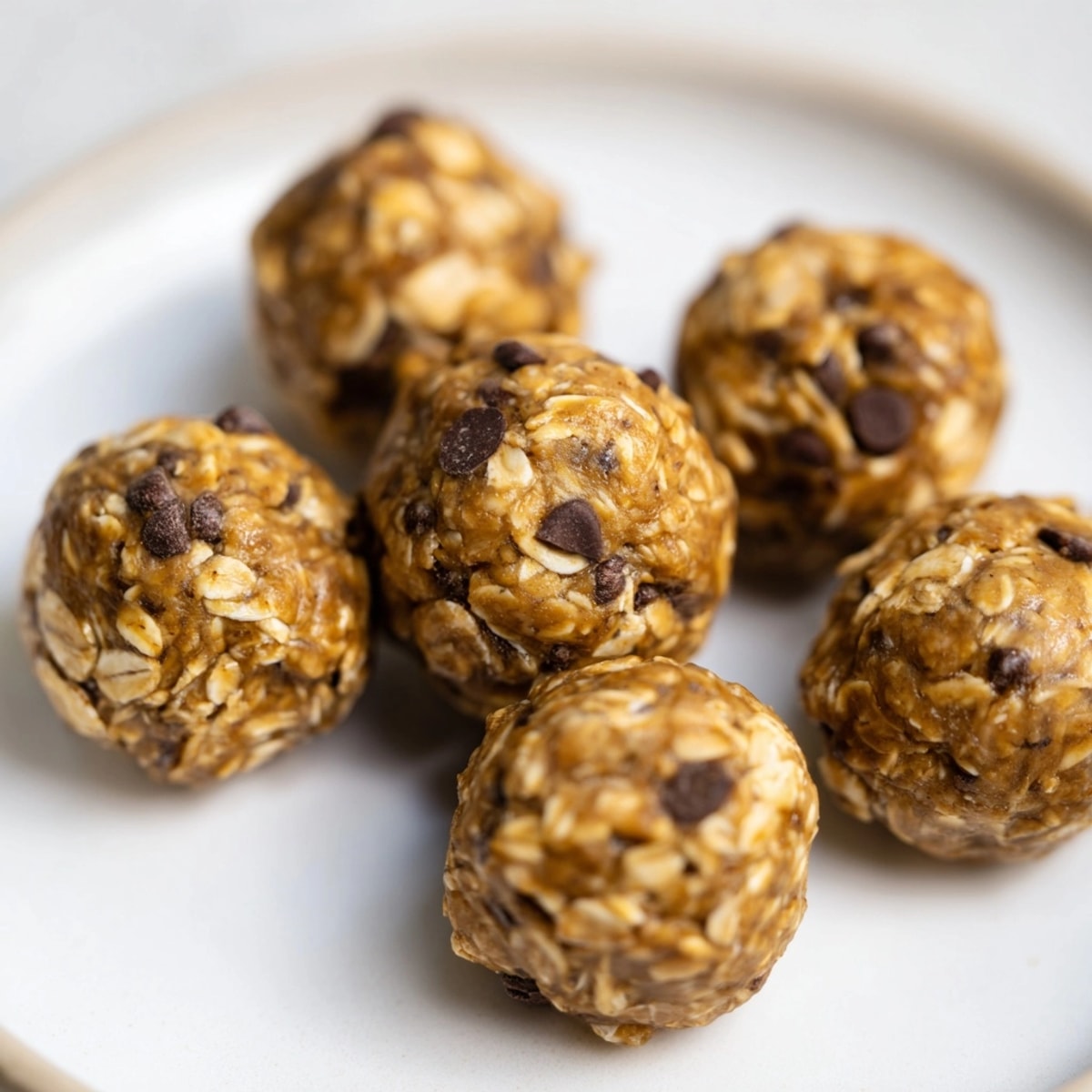 Homemade Peanut Butter Espresso Energy Balls ready to serve, glistening with nutty and sweet richness.