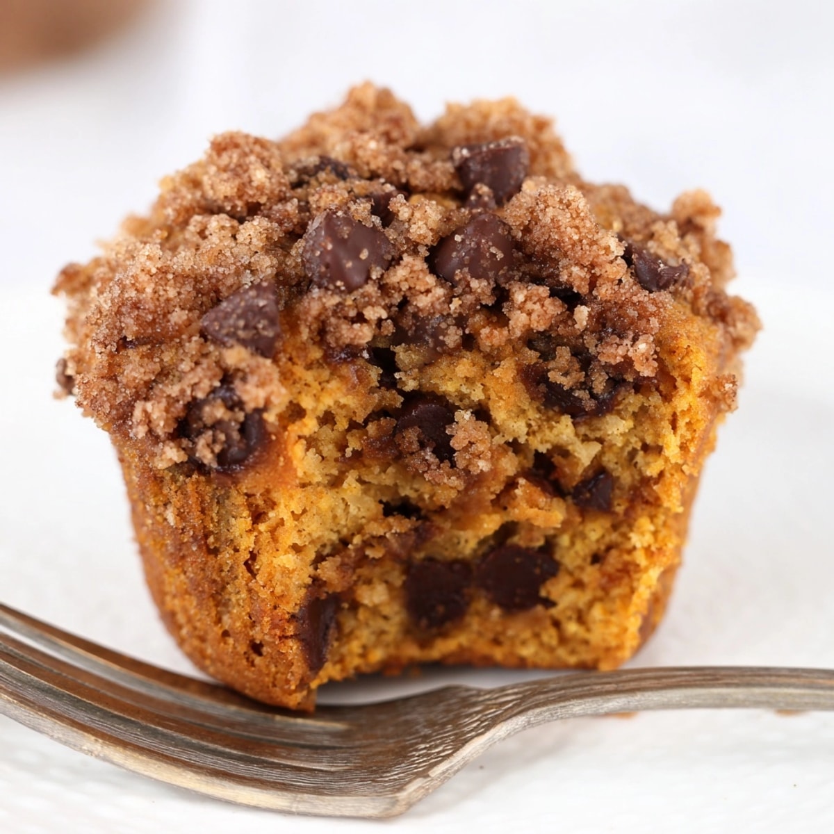 Close-up of bakery-style Pumpkin Chocolate Chip Muffins with a crumbly, sweet streusel.