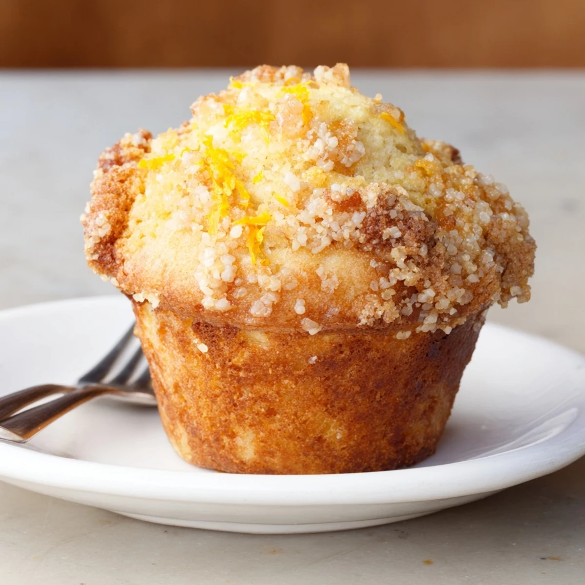 Light and fluffy ricotta citrus banana muffins garnished with sweet turbinado sugar.