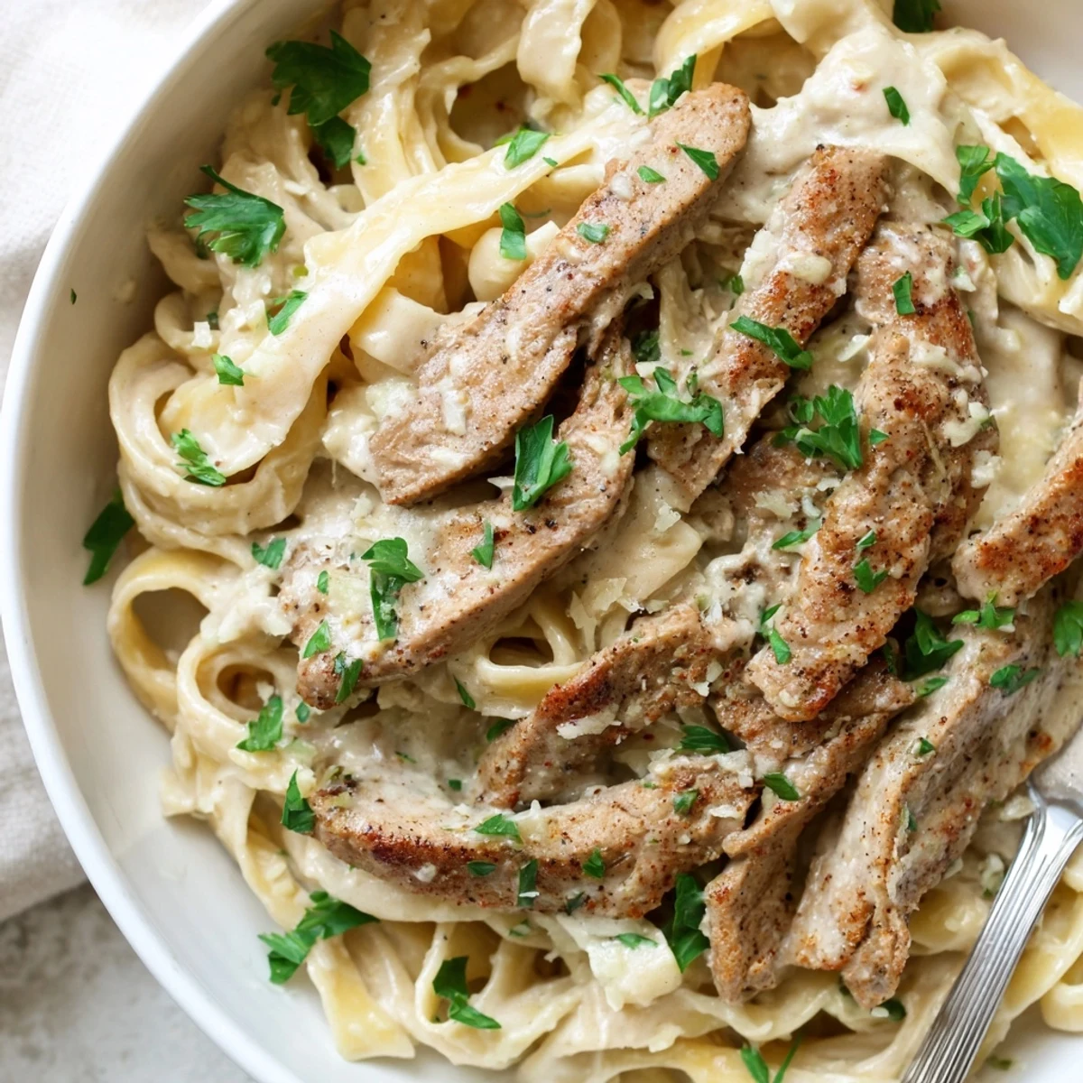 Cajun Spiced Turkey Alfredo with creamy sauce and tender pasta, garnished with parsley.