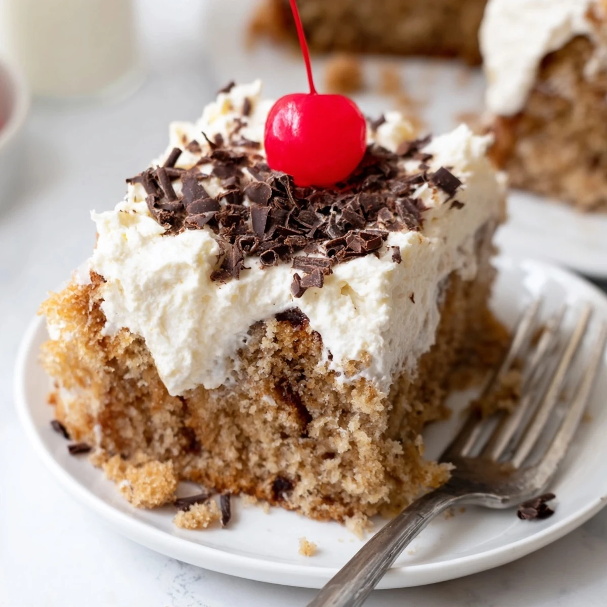 Ultra-moist Rebel Float banana bread topped with creamy frosting, garnished with cherries.  