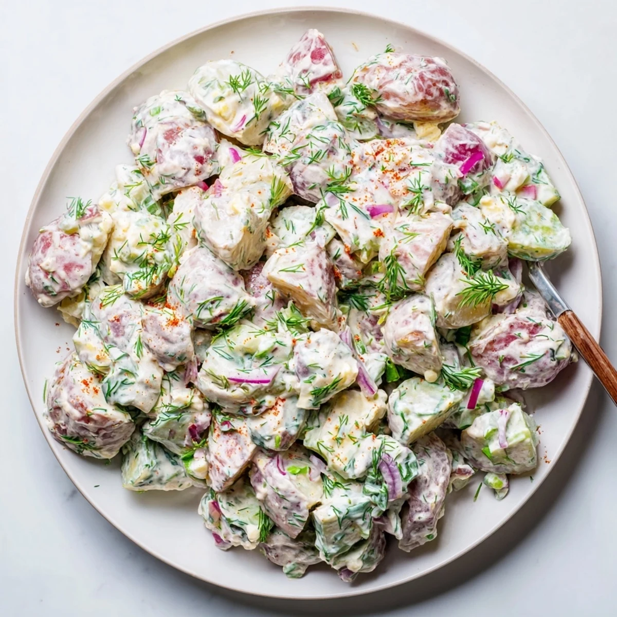 Bowl of zesty Spicy Pickle Ranch Potato Salad, bursting with flavors and textures.