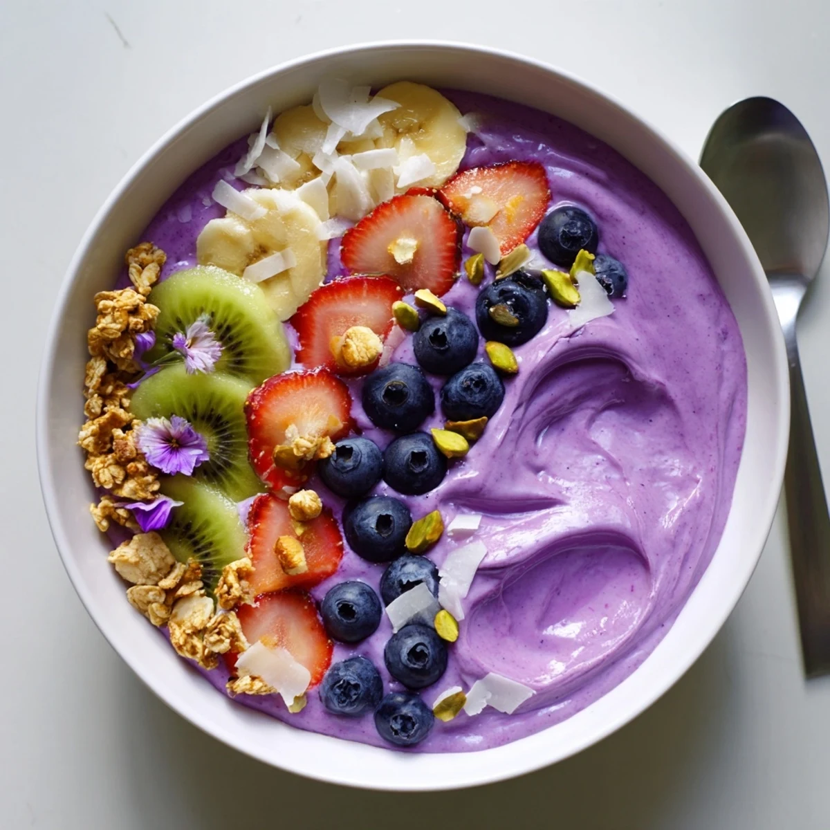 Colorful smoothie bowls featuring creamy yogurt, vibrant fruits, and crunchy toppings.  
