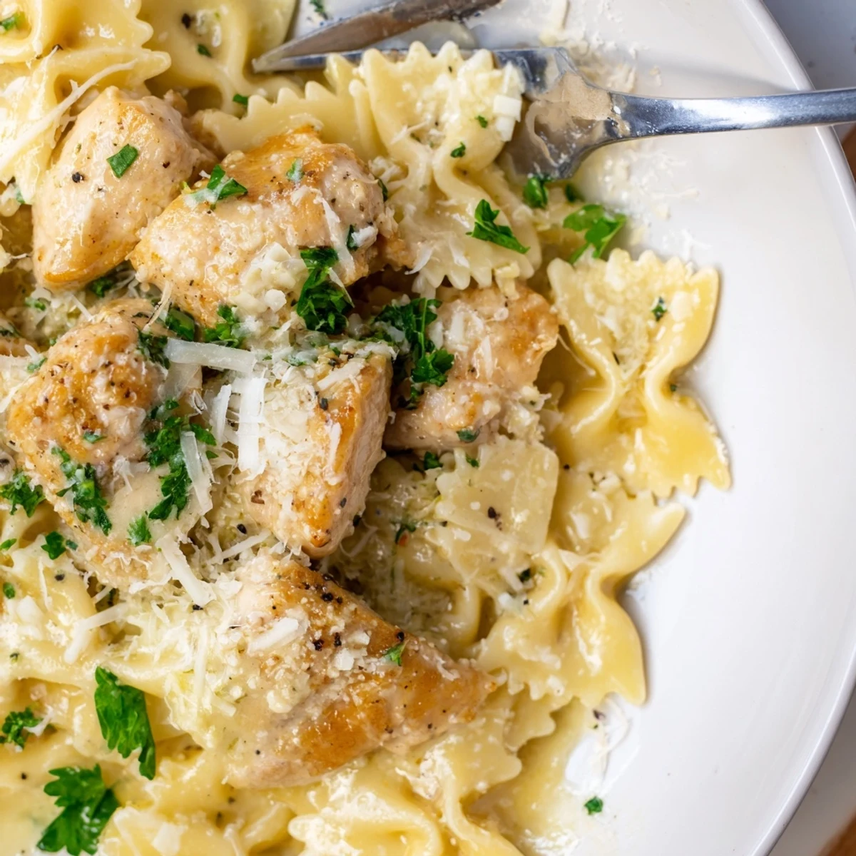 Tender Mozzarella Garlic Butter Chicken Bowties served with fresh parsley and Parmesan.  
