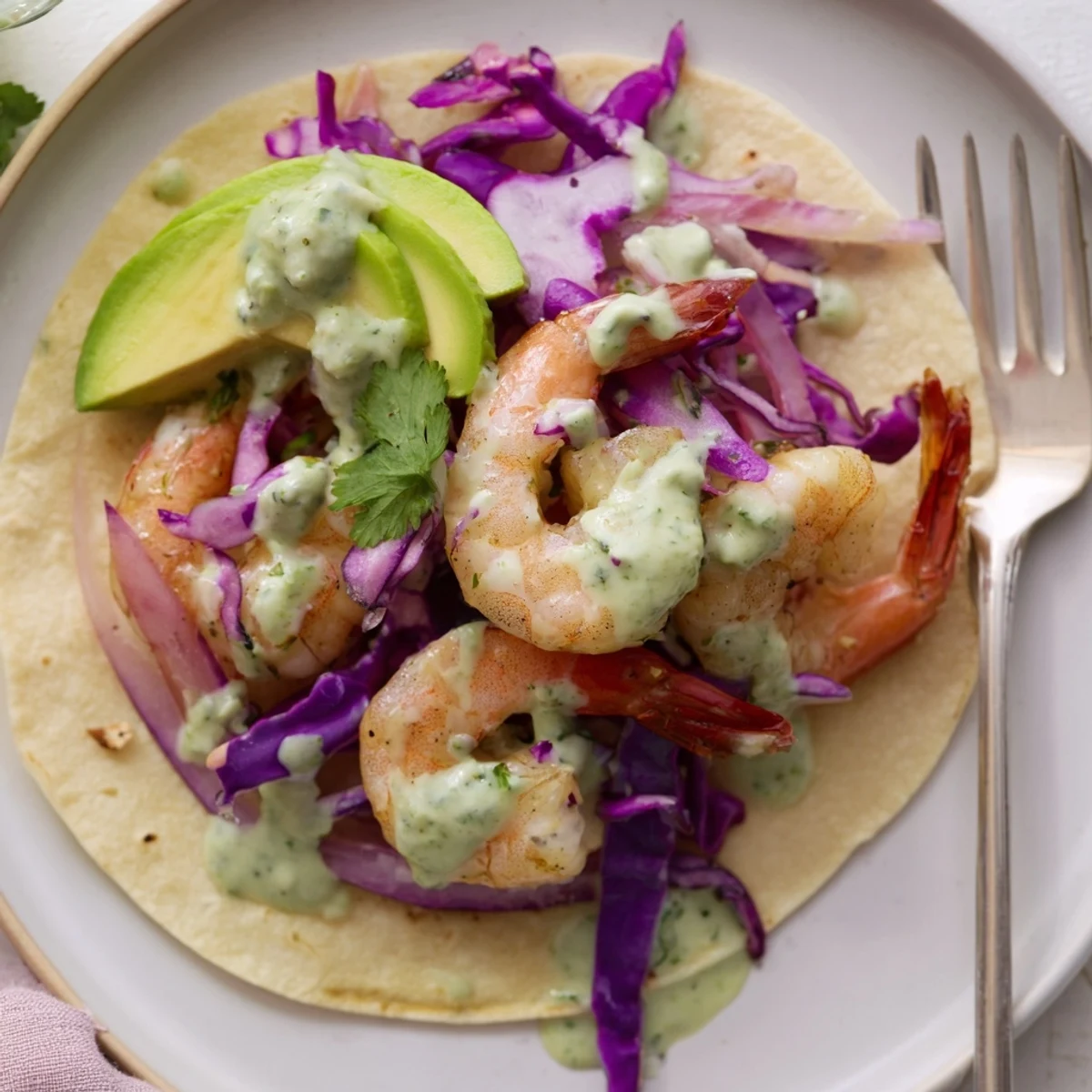 Juicy Lemon Herb Shrimp Tacos topped with creamy cilantro sauce and fresh veggies.  