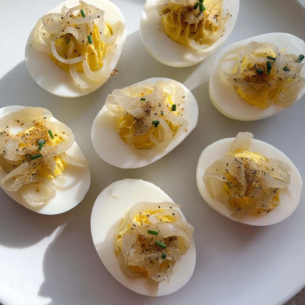 Everything-Spiced Deviled Eggs with Pickled Shallots, perfectly seasoned and garnished, are a delightful appetizer.