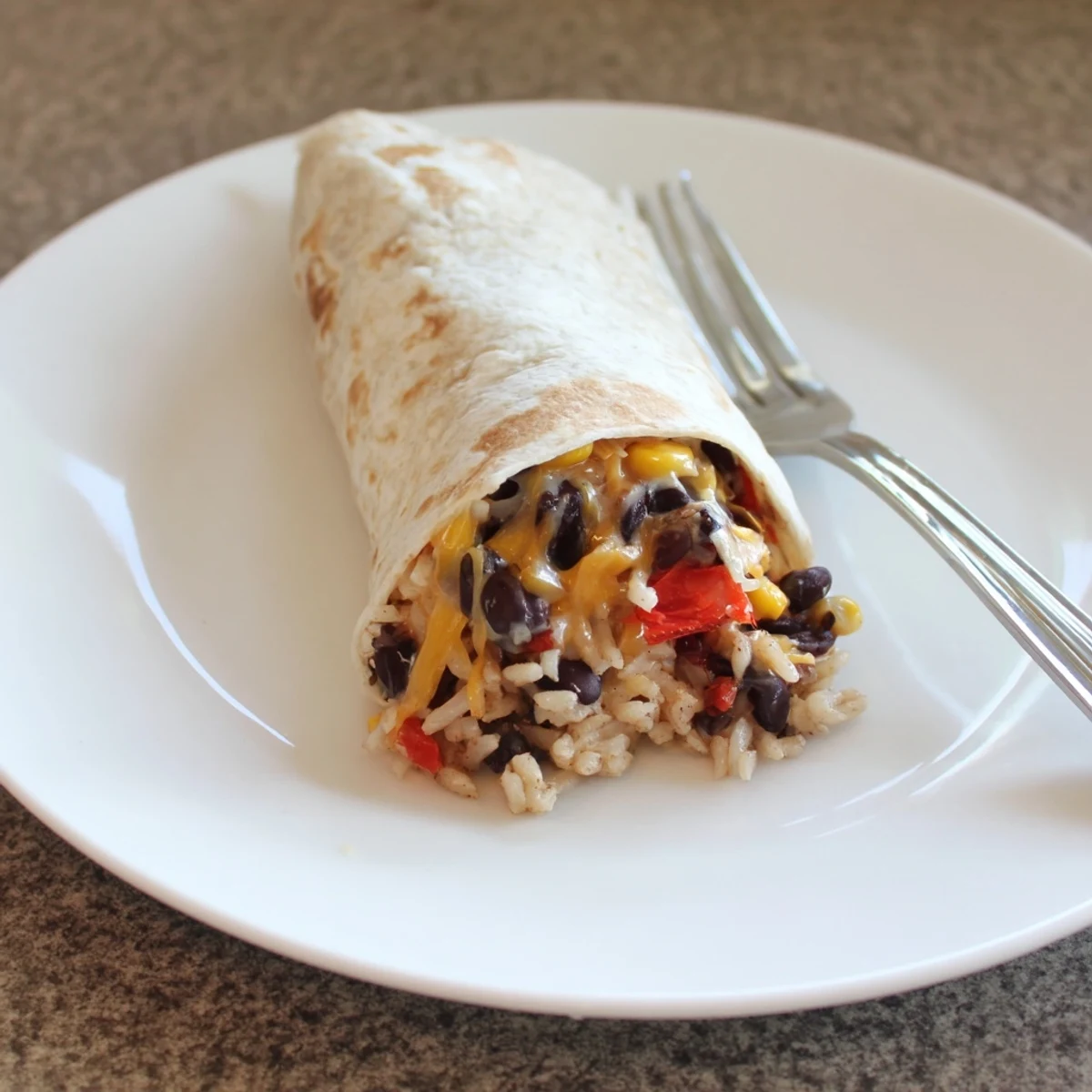 These homemade freezer-friendly burritos are packed with beans, veggies, and cheese; a perfect make-ahead dinner.