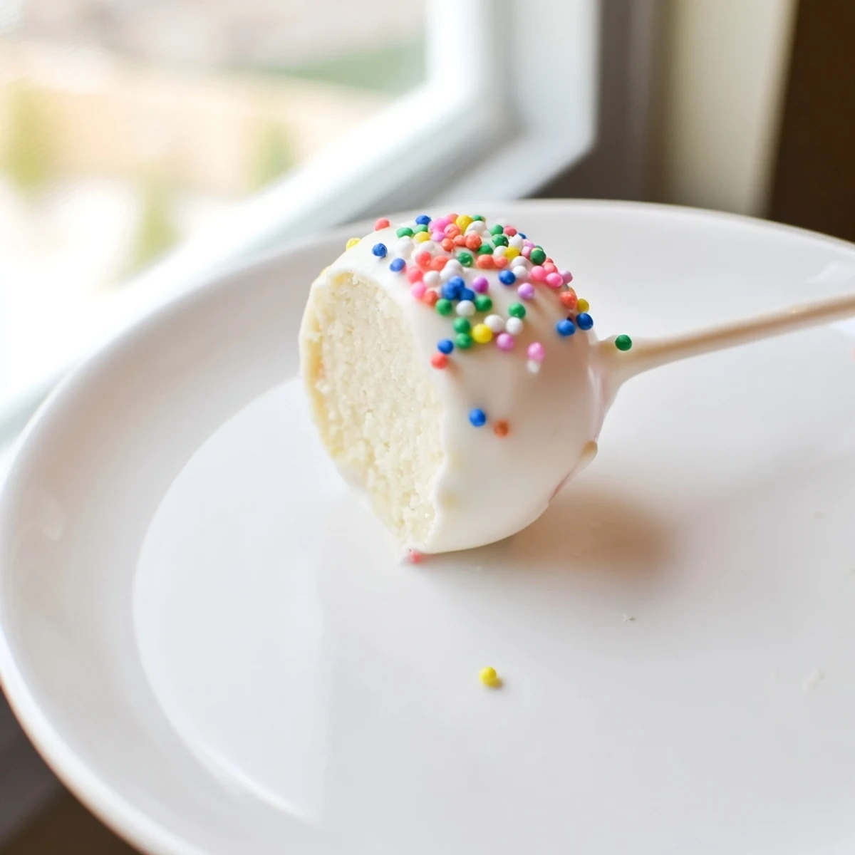 A close-up of delicious lightened-up sugar cookie cake pops, ready to eat and sprinkled.
