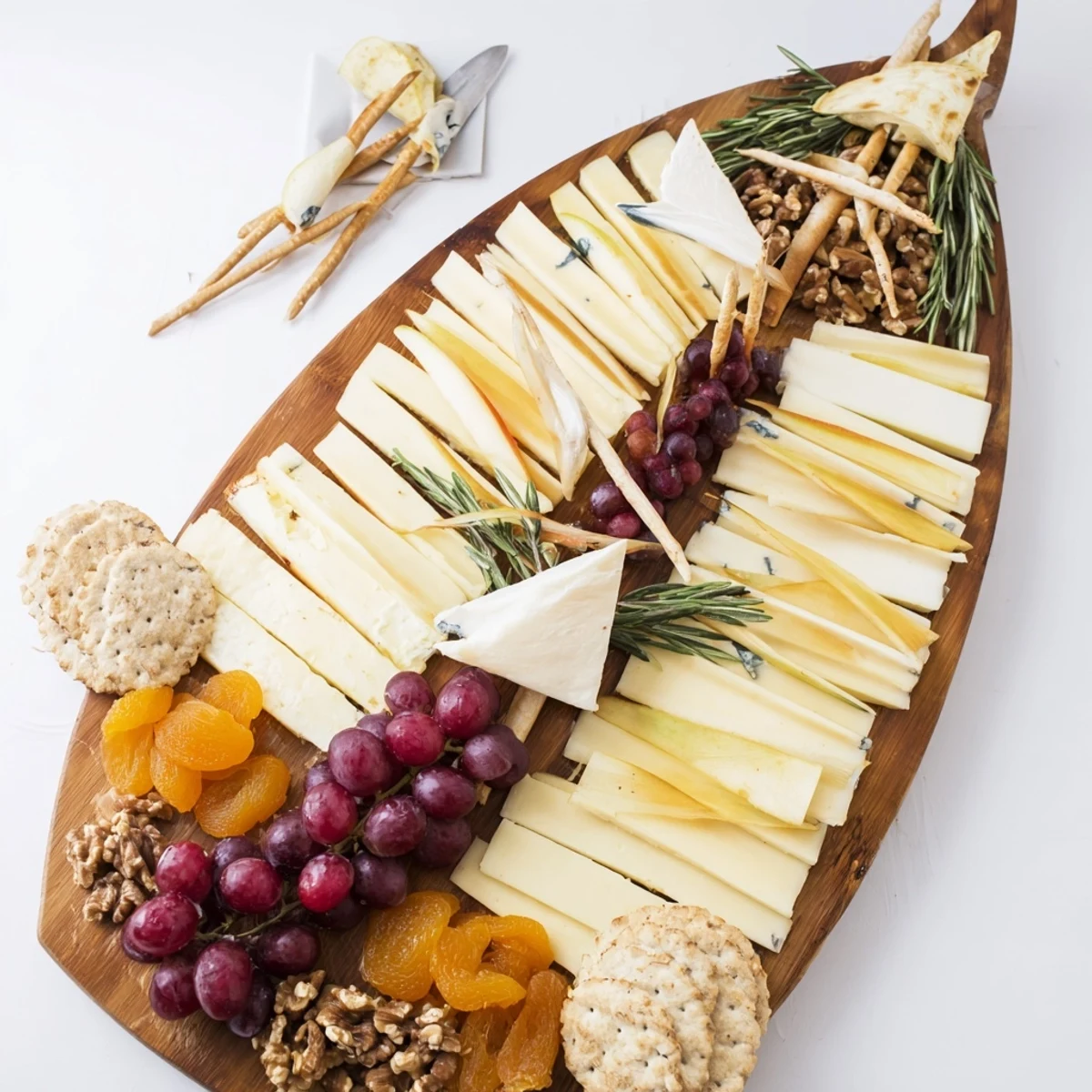 A beautifully arranged Boat cheese platter with brie, grapes, and crackers ready to enjoy.