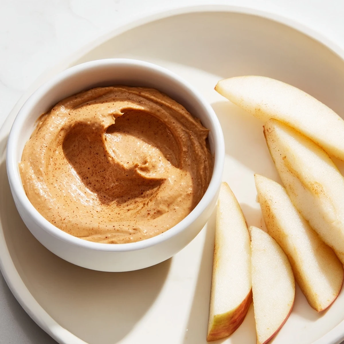 Crisp apple slices ready to be dipped into a creamy peanut butter dip for a delightful snack.
