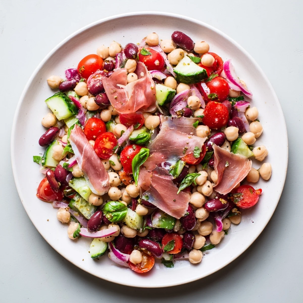 Chilled dense bean salad with prosciutto; envision a flavorful Italian-inspired dish, perfect for lunch or dinner.