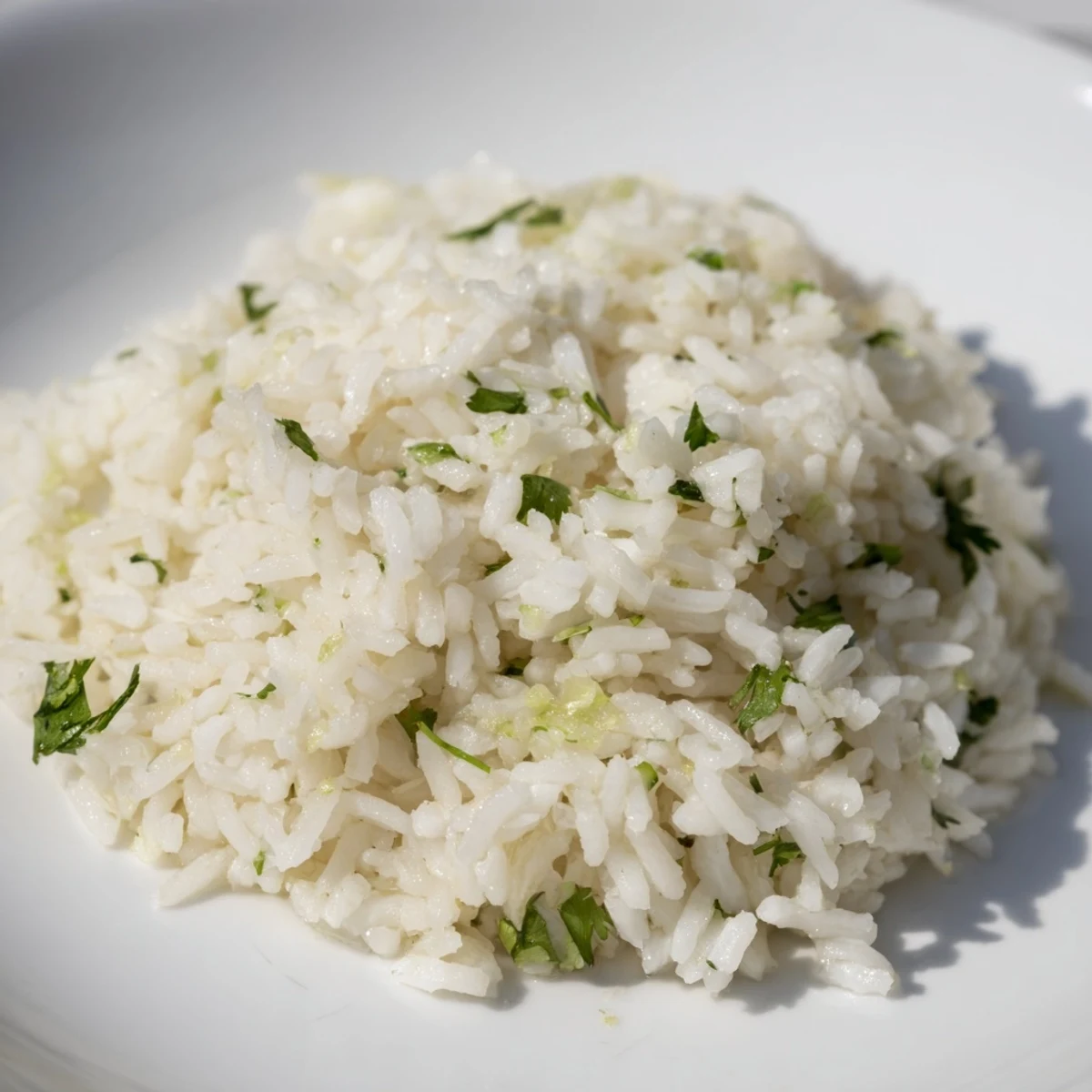 A bowl of fresh Cilantro Lime Rice, showcasing fluffy grains and pops of bright green cilantro.