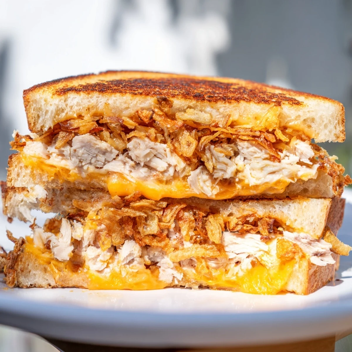 Mouthwatering image of a perfectly toasted Crispy Shallot Chicken Grilled Cheese, ready to eat.