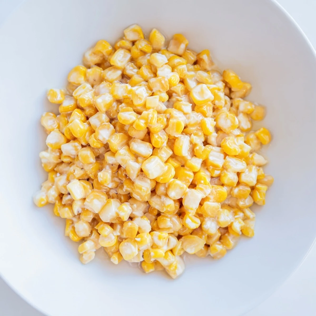 Creamy honey butter skillet corn, perfectly caramelized, offering a blend of sweet and savory flavors for the meal.