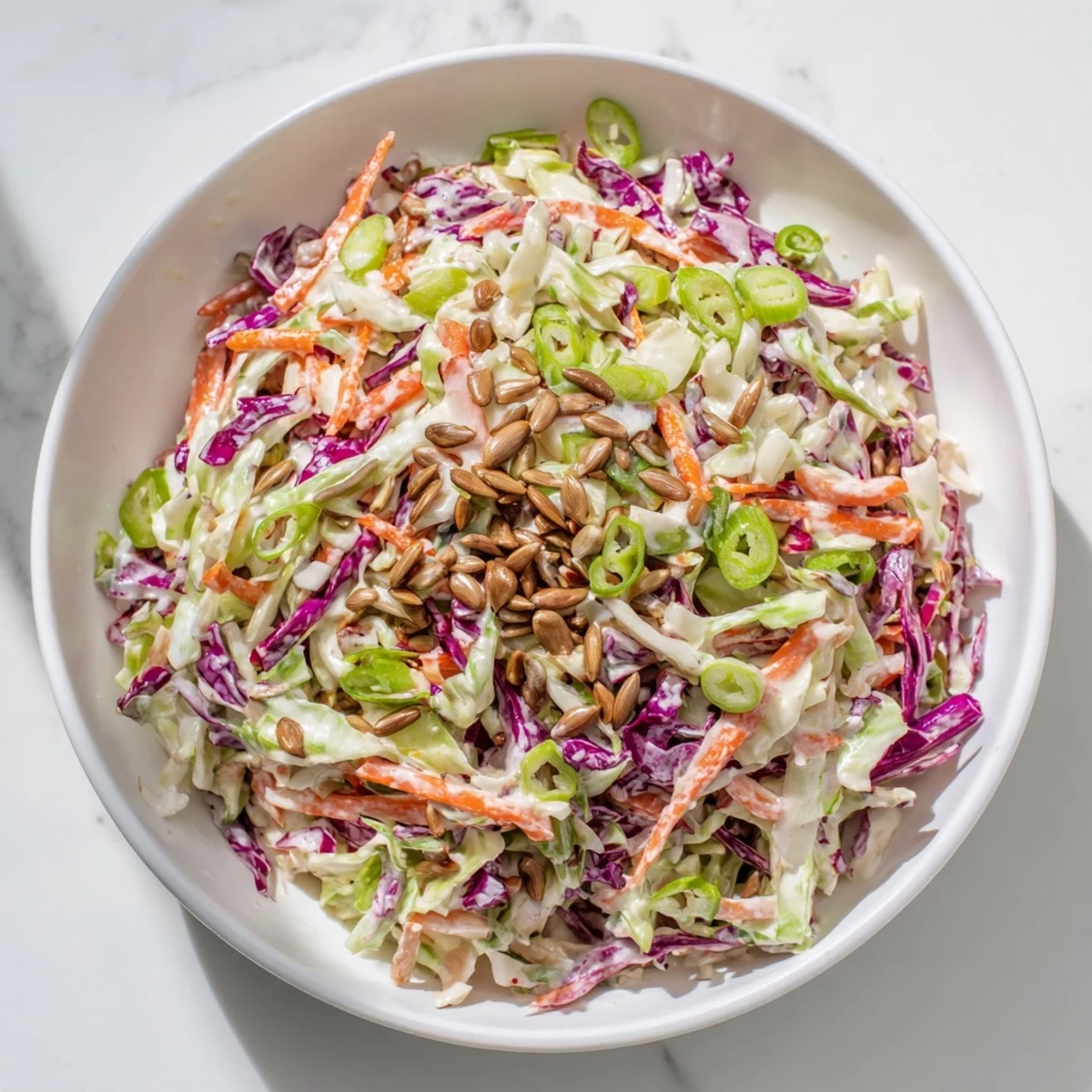 A close-up shot of the vibrant crunchy coleslaw salad, with sunflower seeds adding a lovely crunch.