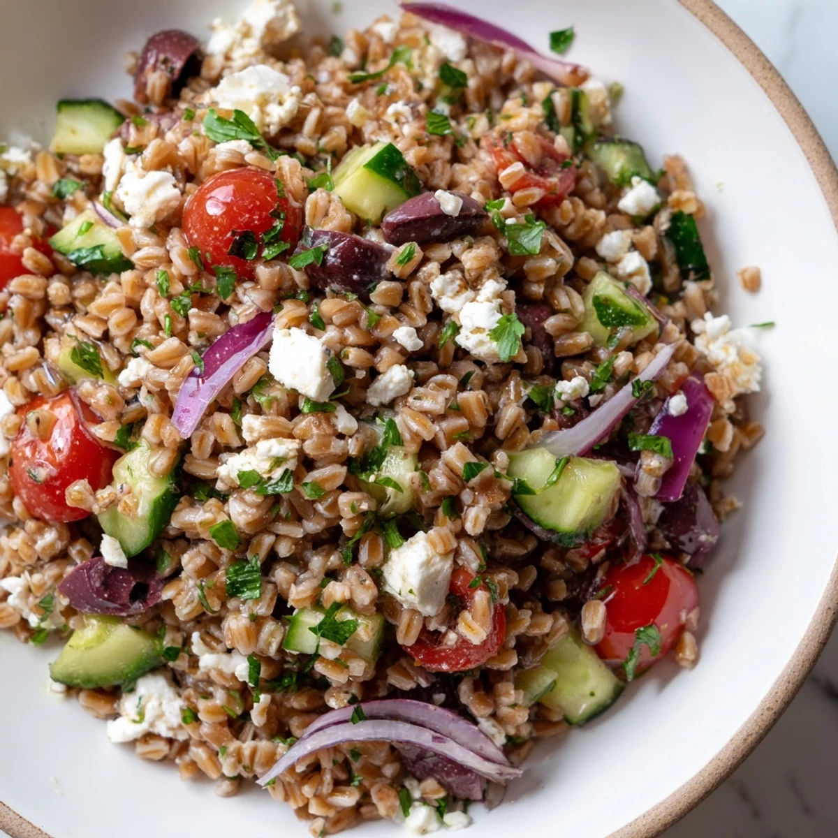Vibrant Farro Salad Mediterranean tossed with tomatoes, olives, and feta, ready to serve for lunch.
