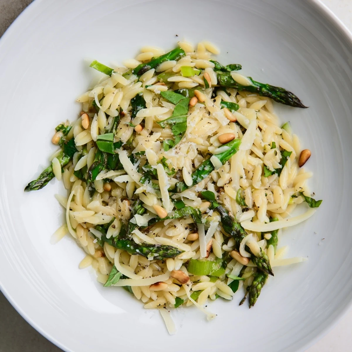 A bright close-up displays the refreshing Asparagus Lemon Orzo Salad, with shaved asparagus ribbons.