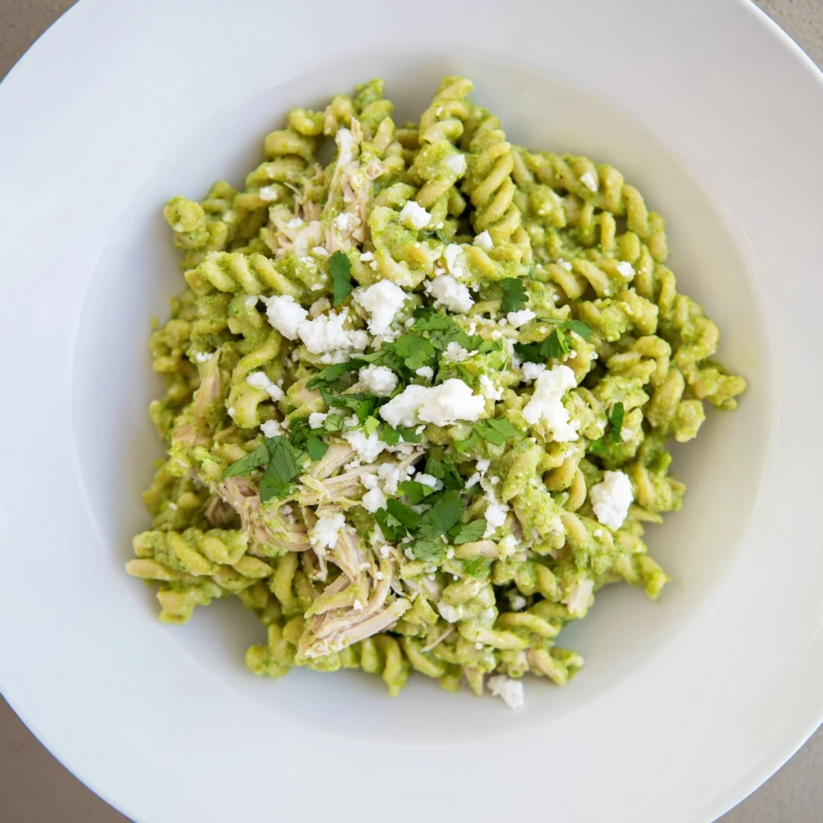 Creamy cilantro lime chicken pasta, a flavorful dish with bright green sauce and rotini.