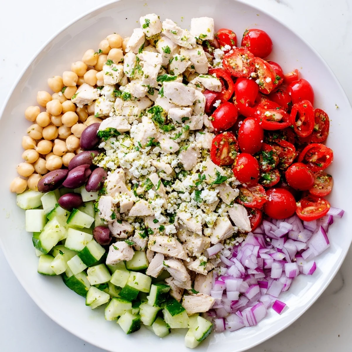 Vibrant Mediterranean Chickpea Chicken Salad brimming with colorful tomatoes and creamy feta cheese, ready to enjoy.
