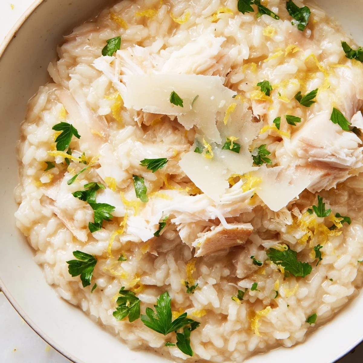 Creamy Smoked Haddock Risotto with tender flaked fish, Parmesan, and fresh parsley on a rustic plate.  