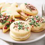 Homemade Festive Christmas Cookie Sandwiches filled with sweet cream, holiday sprinkles, and warm vanilla scent.