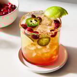 Icy Spicy Thanksgiving Mocktail Margarita in a salt-rimmed, cranberry-garnished glass.