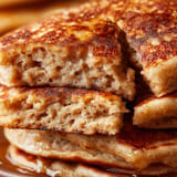 A stack of pancakes with syrup on top.