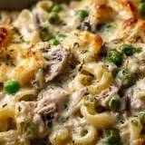A plate of food with peas and noodles.