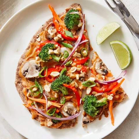 Close-up of Thai Curry Veggie Pita Pizzas, showcasing vibrant vegetable toppings and melted cheese.