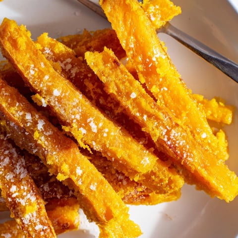 Golden, crispy tempura pumpkin fries, a unique fall treat served with dipping sauce.