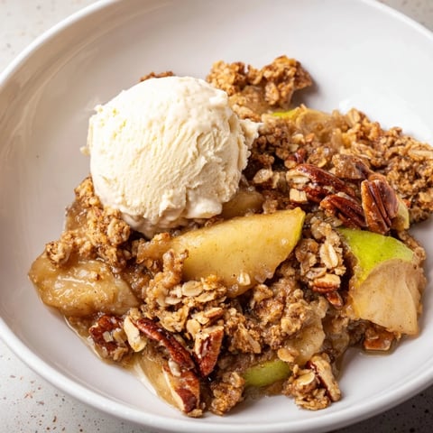 Warm spiced apple and pecan crisp topped with creamy vanilla ice cream.  
