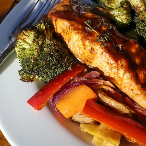Tender maple bourbon glazed salmon served with vibrant roasted vegetables.  