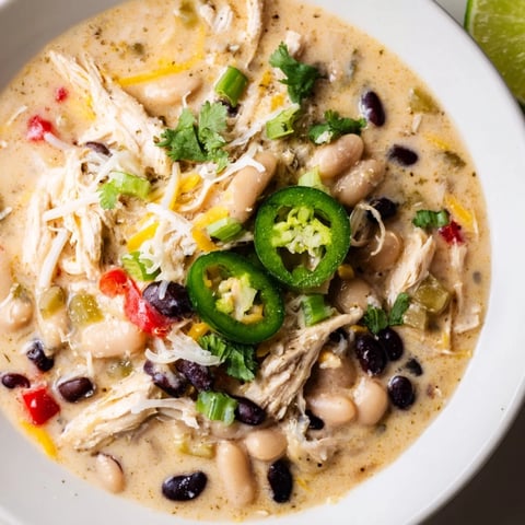 A warm bowl of Slow Cooker White Chicken Chili with a creamy, savory broth and shredded chicken.