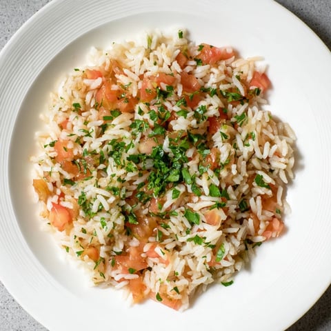 Steaming Tomato-Rice Skillet Dinner, a one-pan meal with fluffy rice and vibrant tomatoes.
