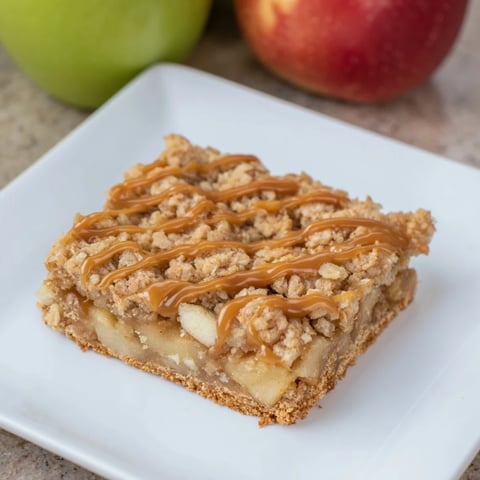 Warm, golden Caramel Apple Cookie Bars with a gooey caramel layer, promising a sweet, comforting bite.