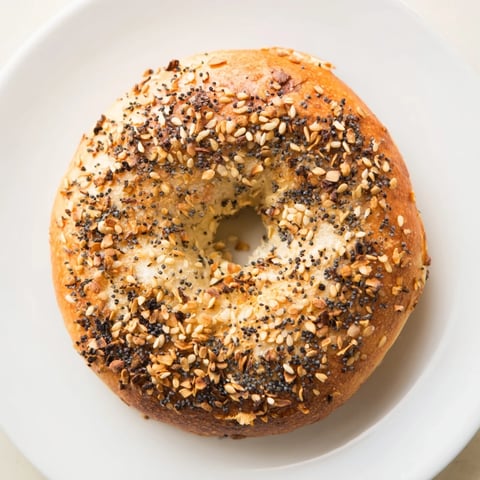 Warm, golden-brown Homemade Budget Bagels, fresh from the oven, offering a delightful chewy texture.