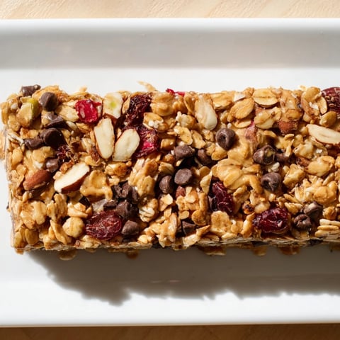 Chewy homemade granola bars, golden brown and packed with oats, perfect for a grab-and-go snack.