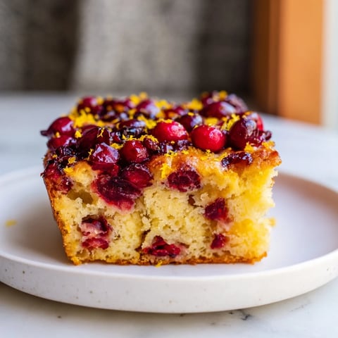 Golden-brown Cranberry Orange No-Knead Focaccia topped with bright cranberries and orange zest, a tempting bread.