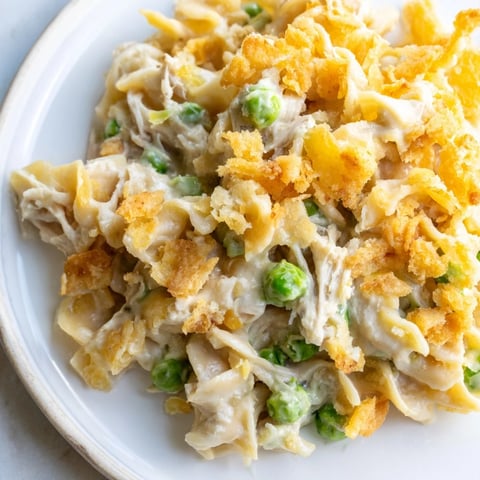 Golden, bubbly Creamy Tuna Noodle Casserole with a crispy Ritz cracker crust, ready to enjoy.