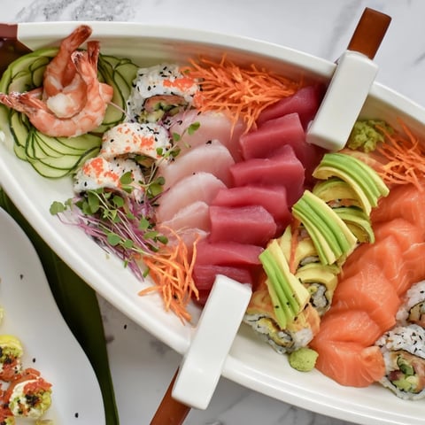 Sail Away Boat-Shaped Sushi Platter: A vibrant display of colorful sushi arranged to resemble a beautiful boat.