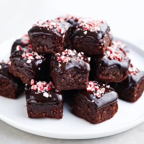 Fudgy Peppermint Mocha Brownie Bites, drizzled with chocolate glaze, make a perfect holiday treat.