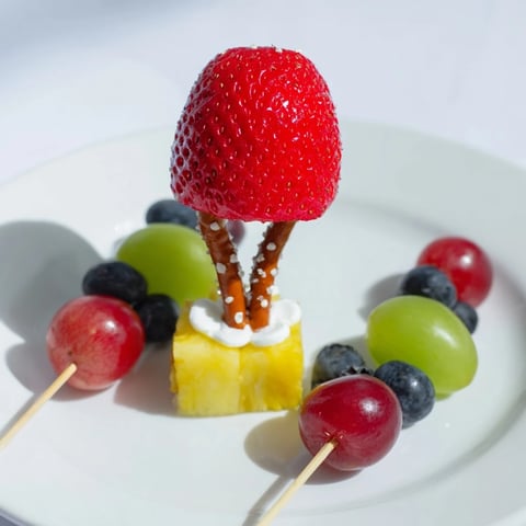 Christmas Light Fruit Skewers bursting with colorful fruit, ready for a fun, healthy snack at your holiday party.