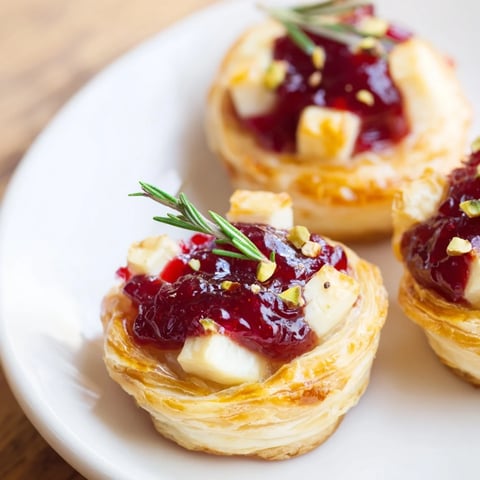 Golden, flaky Mini Cranberry Brie Tart Wreath with melting cheese, vibrant cranberry topping, ready to enjoy.