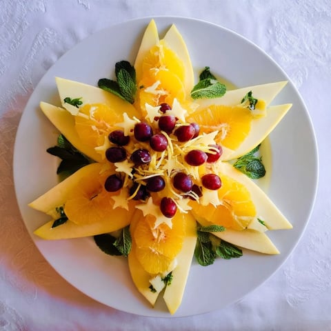 Plate of brunch fruit: Sliced starfruit and grapes, a colorful, refreshing garnish option.
