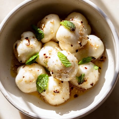 Creamy mozzarella pearls in a bowl, a simple Italian appetizer, seasoned to perfection.