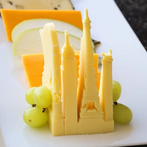 Skyline Silhouette cheese platter: architectural cheese slices with fresh fruit and crackers.
