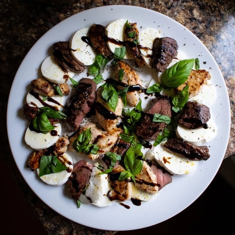 Savory Safari Stripes appetizer showcasing balsamic-glazed beef and chicken strips with creamy cheese for a striking presentation.