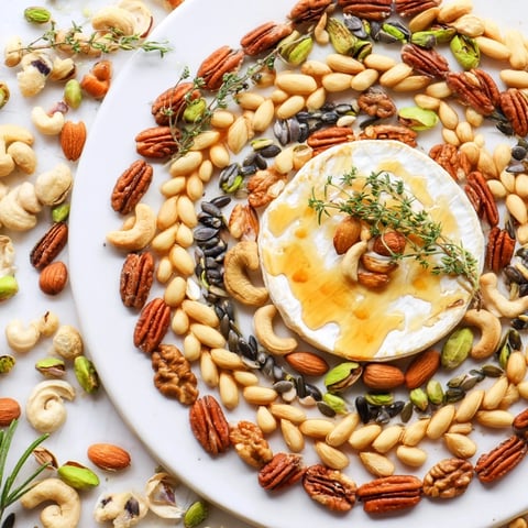 The Labyrinth appetizer features a maze of mixed nuts and seeds surrounding creamy, soft cheese.