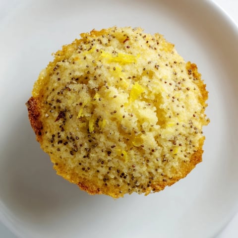 Fluffy lemon poppy seed muffins, golden brown and drizzled with a sweet lemon glaze.